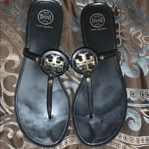 Tory Burch black letter sandals.